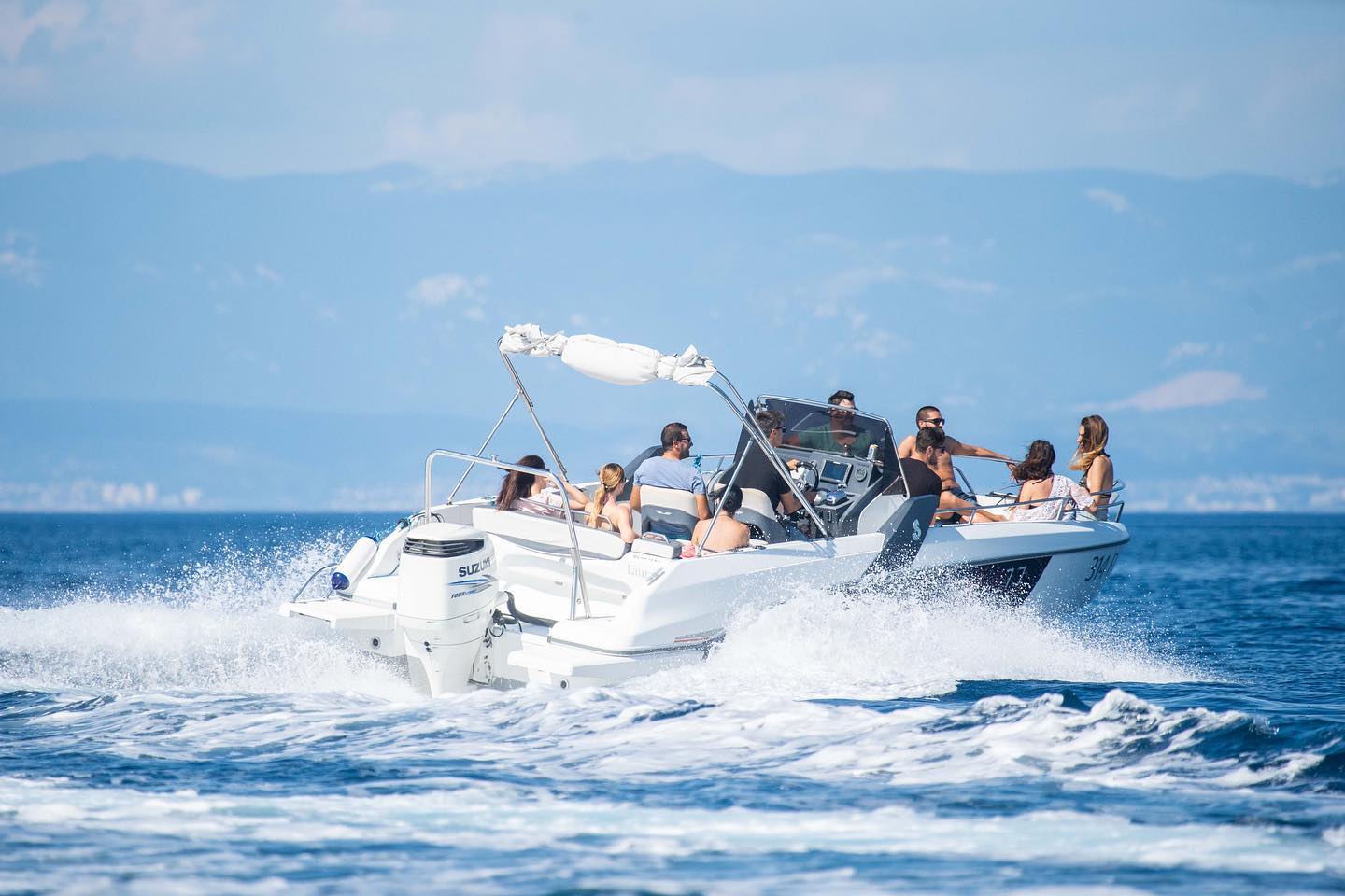 High-speed boat racing through waves with powerful Honda 250HP engine
